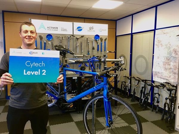 James Thornton holding his Cytech Level 2 certificate at Activate Cycle Academy